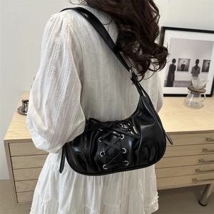 Chic black corset-style shoulder bag with silver eyelets and drawstring ribbon details