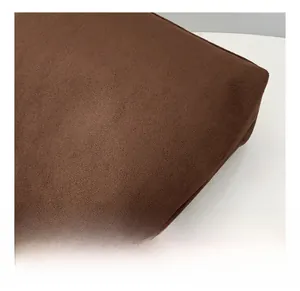 Detailed close-up of dark brown suede texture on a high-capacity fashion tote bag