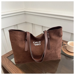 Macro shot of dark brown matte tote bag texture with white logo print details