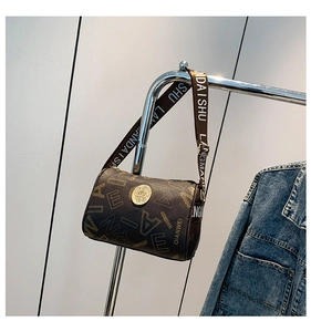 Detail of dark brown cylinder boston bag with letter print and wide jacquard strap