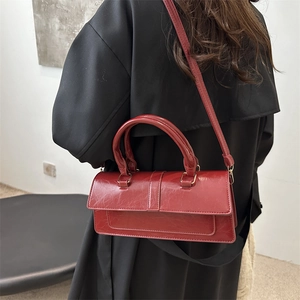 Chic red retro baguette shoulder bag in glossy pleated leather for women's fashion