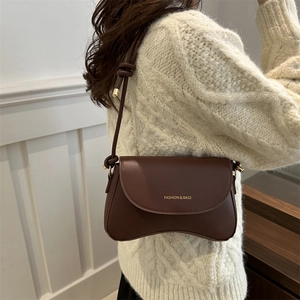 Dark brown matte PU leather shoulder bag with curved base and adjustable knotted strap