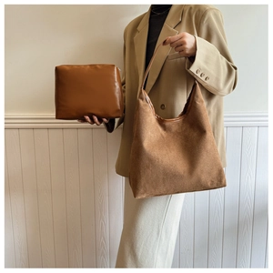 Detailed view of brown two-piece tote bag set with textured matte finish and clutch