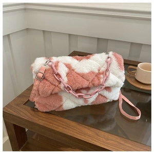 Detailed macro view of pink and white checkered faux fur plush bag with acrylic chain link