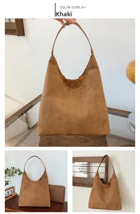 Detail view of khaki hobo tote bag in matte suede texture with matching small pouch