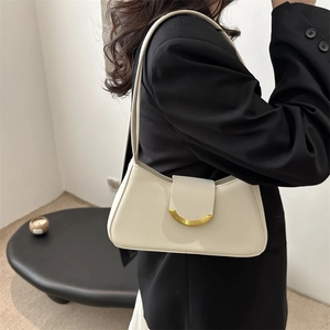 Minimalist off-white underarm bag with gold semicircular buckle for daily commute