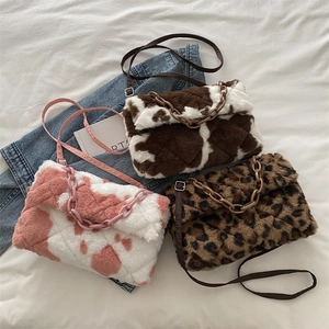Faux fur leopard and cow print shoulder bags with chunky chains for autumn and winter
