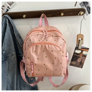 Detailed view of pink floral backpack with high-density nylon fabric and side buckle