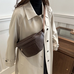 Dark brown woven leather chest bag for women with adjustable strap and golden hardware