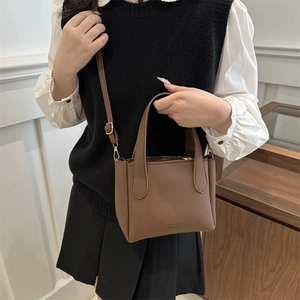 Brown litchi grain PU leather bucket bag with top handles and adjustable strap