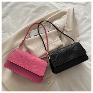 Detail of woven texture flap and smooth material contrast on stylish shoulder bags