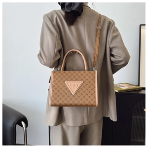 Rear view of model wearing a vintage brown geometric pattern tote bag with shoulder strap
