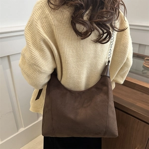 Retro dark brown suede hobo bag with silver chain strap shown on model shoulder