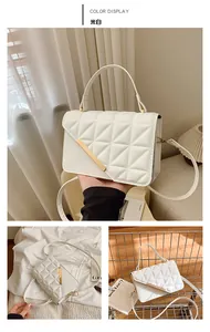 Détail du sac à main matelassé blanc cassé avec boucle dorée et bandoulière chic