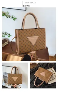 Detail view of brown monogram tote bag with triangle logo and detachable shoulder strap