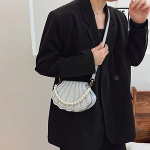 Silver shell-shaped crossbody bag with glitter texture and elegant pearl handle detail