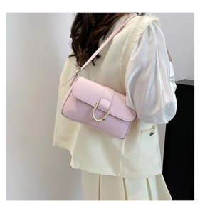 Detail of the pink glossy leather underarm bag with a golden U-shaped metal buckle