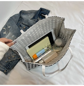 Interior view of houndstooth tote bag showing large capacity for tablet and cosmetics