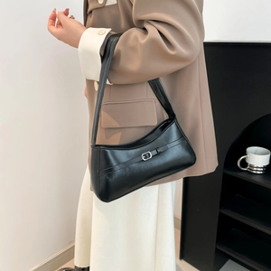Minimalist black faux leather shoulder bag with vintage buckle and pebble texture