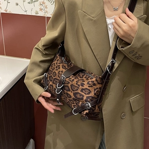 Large leopard print tote bag with brown leather straps and silver buckle accents