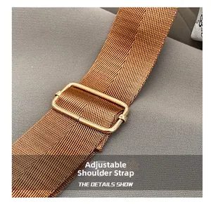 Detail of adjustable woven brown shoulder strap with premium gold metal buckle for tote bags