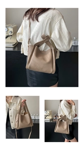 Macro detail of camel litchi grain leather bucket bag with fashion logo embossing