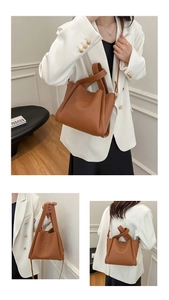 Close-up of caramel brown lychee pattern leather bucket bag with FASHION embossed detail