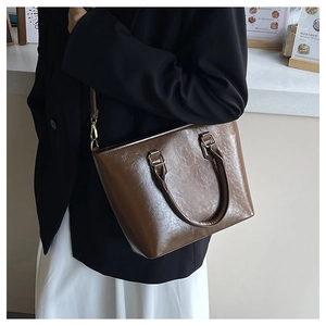 Brown pleated texture PU leather crossbody bag worn by a model in a cafe setting