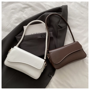 Detailed view of flap closure and wave-edge design on stylish retro PU leather handbags