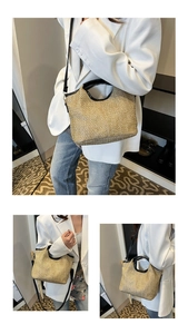 Macro shot of straw tote bag with black leather trim and detachable shoulder strap