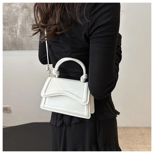 Chic white PU leather handbag with unique curved flap and decorative stitching detail