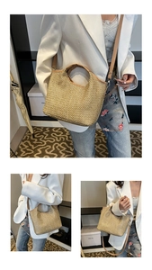 Detail view of woven straw tote bag with brown leather handles and adjustable shoulder strap