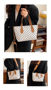 Close-up of cream tote bag with vintage floral prints and brown leather handles