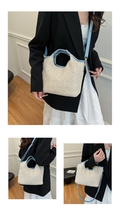 Detailed texture of beige woven straw tote bag with light blue adjustable leather strap