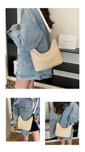 Detail of beige woven hobo bag showing mesh texture, leather strap and gold metal hooks