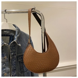 Detail of brown hobo crescent bag with crocodile pattern and adjustable shoulder strap