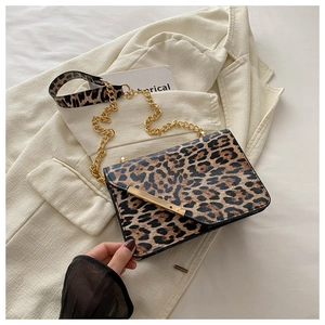 Detail of leopard print crossbody bag with gold hardware and stylish detachable wide strap