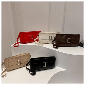 Detailed view of women's underarm bags in five colors with silver buckles on white stands