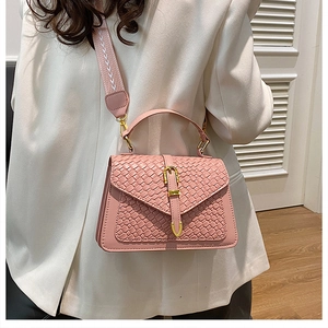 Pink woven square bag detail with gold buckle and stylish wide fabric shoulder strap
