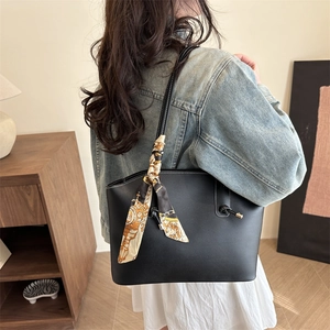 Minimalist black lychee texture tote bag with vintage scarf accessory on model