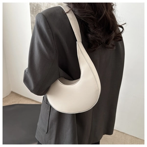Close-up of the vintage cream crescent shoulder bag with detailed stitching and matte leather