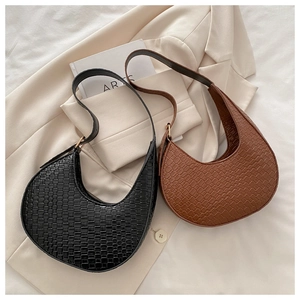 Detailed view of black and brown woven crescent bags with adjustable shoulder straps