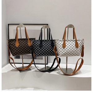 Detailed display of vintage printed tote bags in coffee brown, navy, and white colors