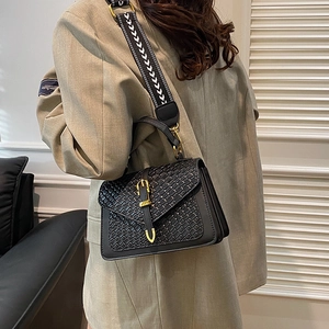 Fashionable black woven crossbody bag with gold buckle and retro patterned wide strap