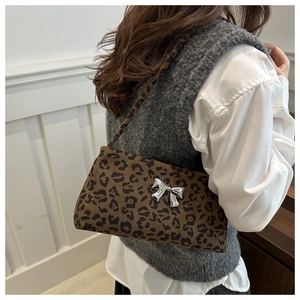 Detail of vintage leopard print shoulder bag featuring a 3D silver butterfly buckle