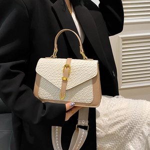 Women woven crossbody bag with wide patterned strap and golden metal buckle details
