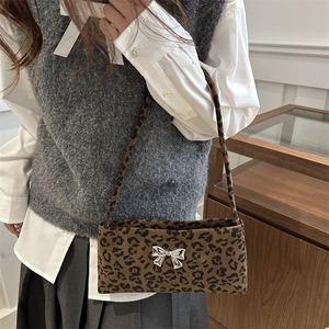 Fashionable leopard print underarm bag with a silver metallic butterfly buckle decoration