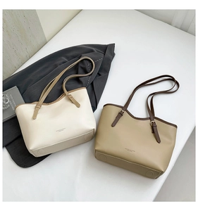 Detailed shot of the adjustable metal buckle and leather strap on a minimalist tote bag