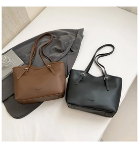 Detailed comparison of brown and black leather tote bags with minimalist fashion logo