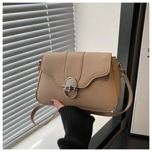Dettaglio borsa a tracolla color crema con chiusura vintage argento e pelle opaca